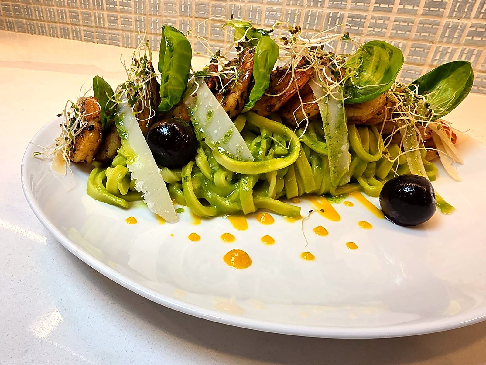 Green pasta with grilled prawns and shaved parmesan