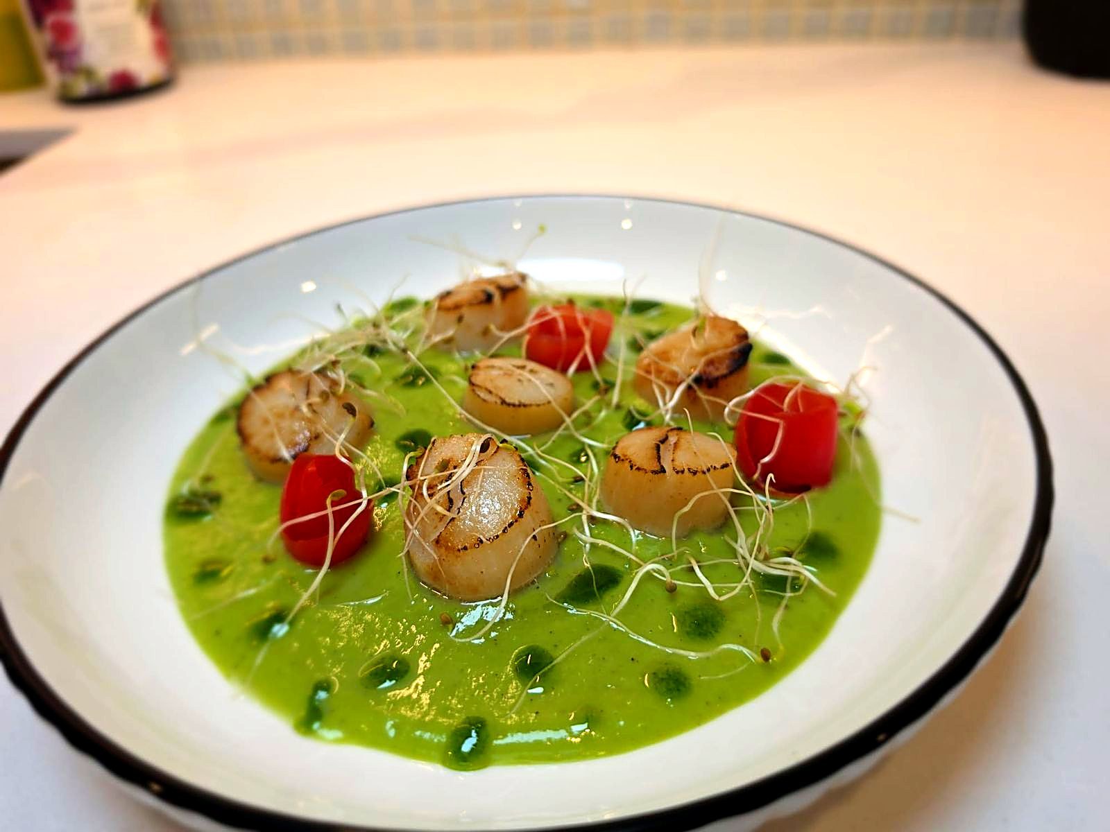 Seared scallops on pea velouté